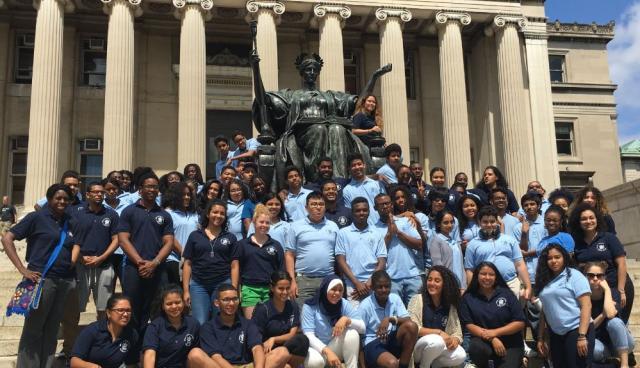 Double Discovery Center students pose in front of Alma Mater.